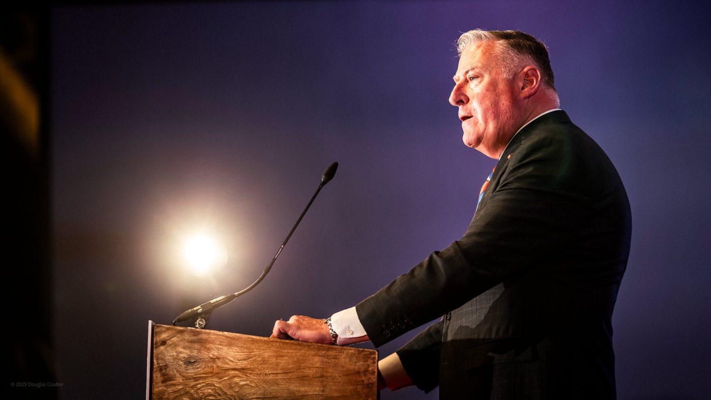 John King speaking at a podium